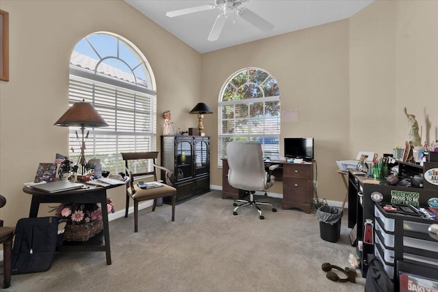 home office featuring carpet, baseboards, and a ceiling fan