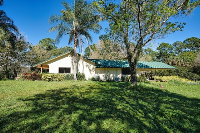 view of side of property with a yard