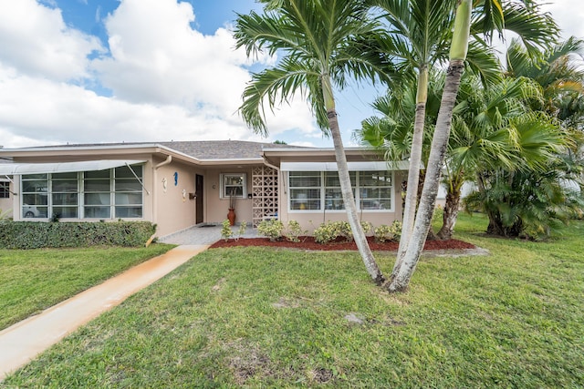 ranch-style home with a front yard