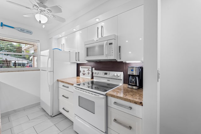 kitchen featuring light stone countertops, white appliances, white cabinetry, and ceiling fan