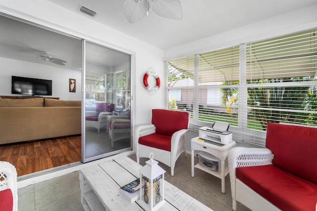 sunroom / solarium featuring ceiling fan