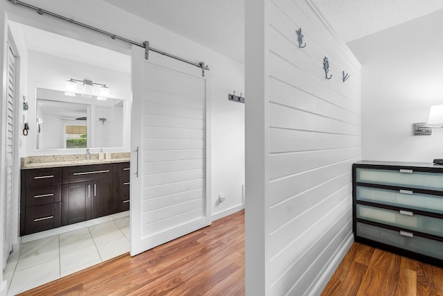 bathroom with vanity, a textured ceiling, and hardwood / wood-style flooring