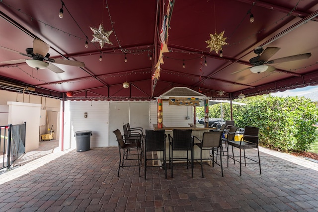 view of patio / terrace with a bar and ceiling fan