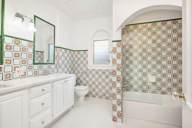 full bath featuring tile patterned flooring, toilet, double vanity, tile walls, and a sink