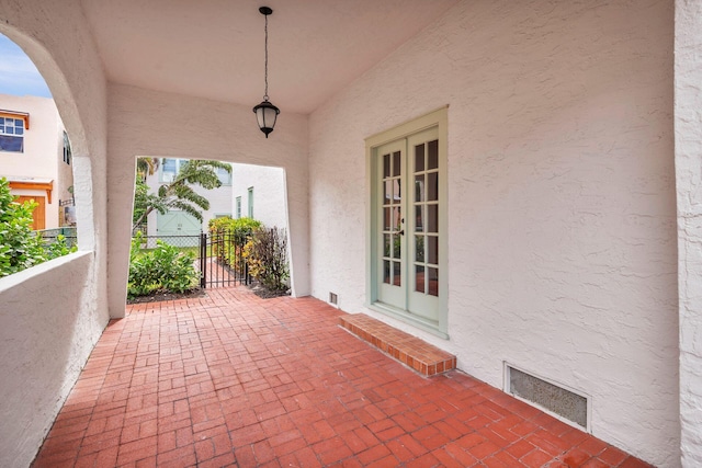 view of patio / terrace featuring visible vents, fence, and french doors