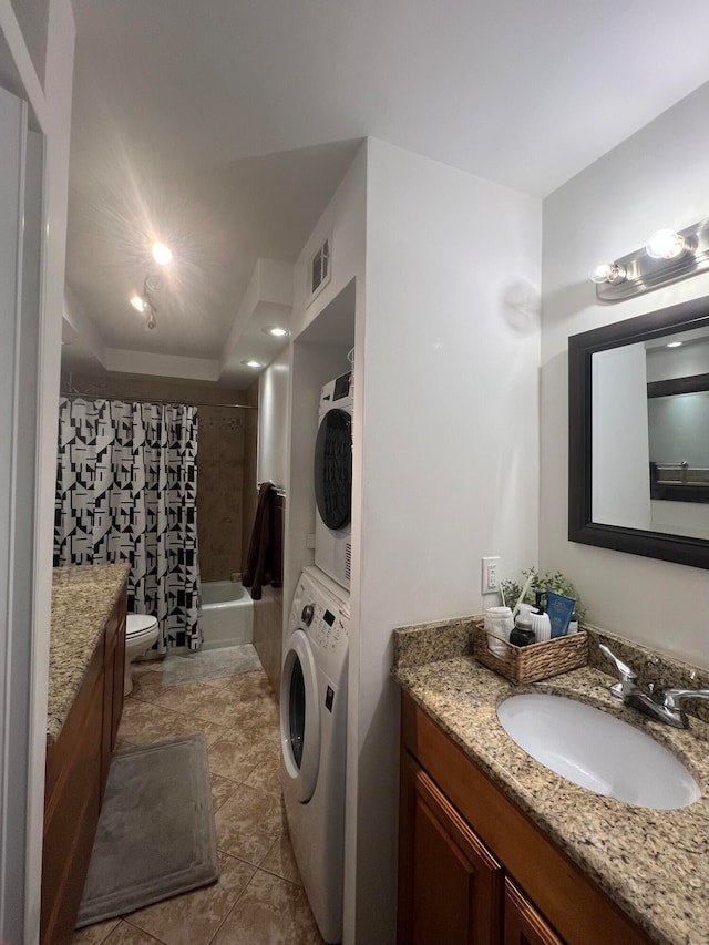 laundry area featuring light tile patterned flooring, stacked washer / drying machine, and sink