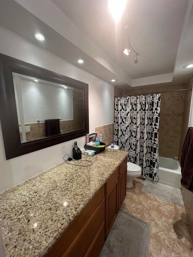 full bathroom featuring vanity, toilet, shower / tub combo, and a raised ceiling