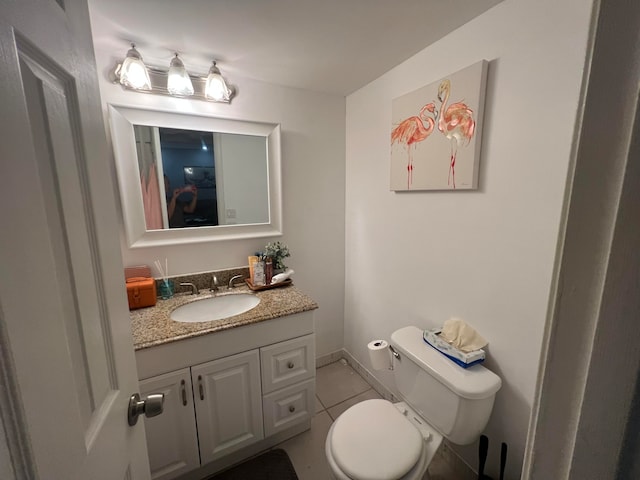 bathroom with vanity, toilet, and tile patterned flooring