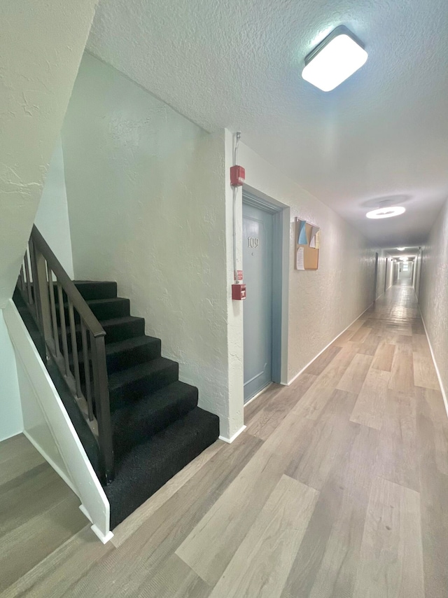 interior space featuring hardwood / wood-style floors and a textured ceiling