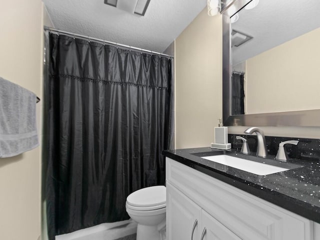 bathroom featuring vanity, toilet, a shower with curtain, and a textured ceiling