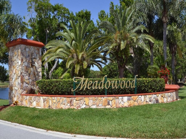 community sign featuring a lawn