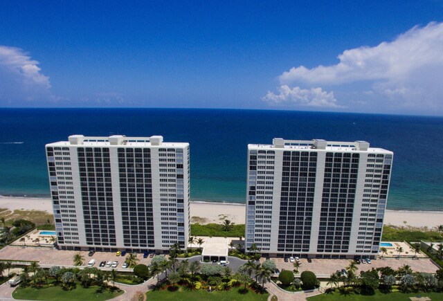 drone / aerial view featuring a water view and a beach view