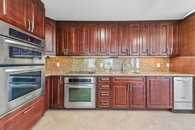 clothes washing area featuring stacked washer / dryer and light tile flooring