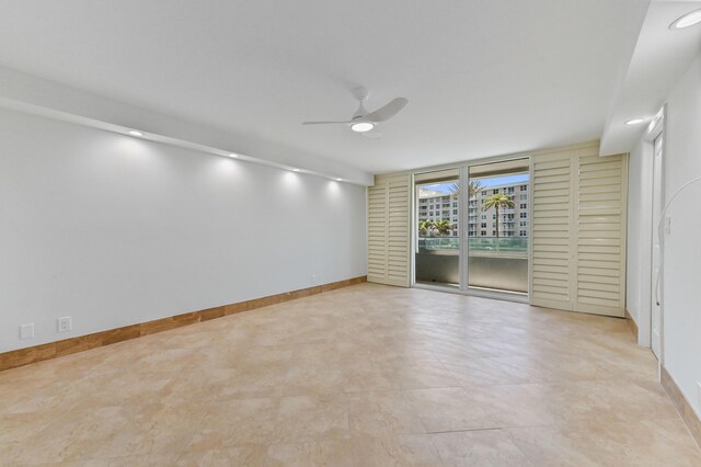 unfurnished bedroom featuring ceiling fan and light tile floors