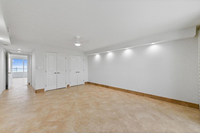 empty room with light tile floors and ceiling fan