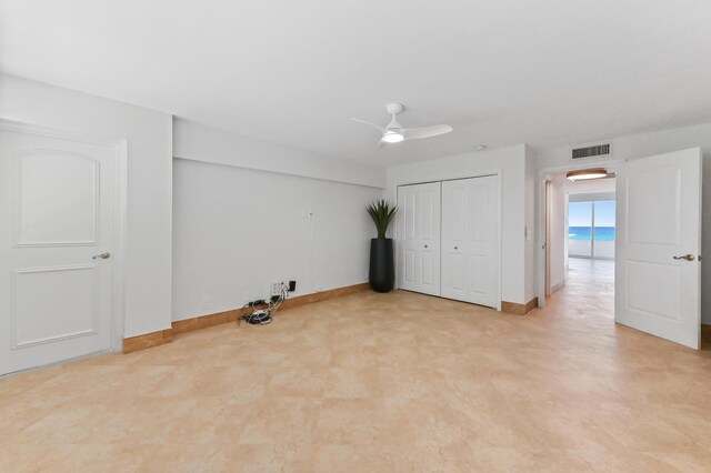 hallway with light tile floors and a drop ceiling