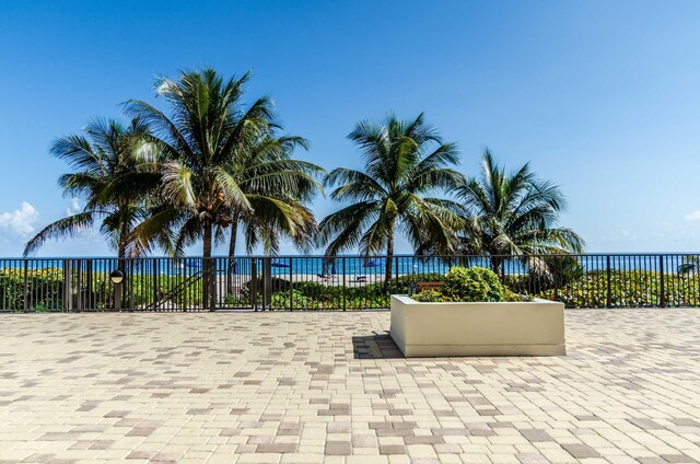 view of building exterior with a view of the beach and a water view