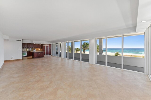 unfurnished living room featuring light tile floors