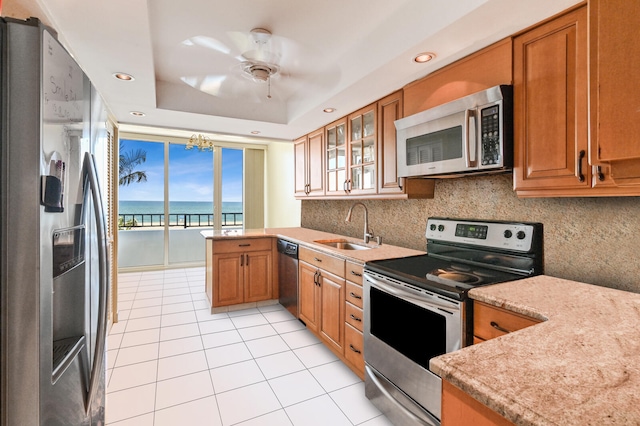 2800 S Ocean Blvd Unit 2-A, Boca Raton, FL 33432 - kitchen featuring a sink, appliances with stainless steel finishes, light tile patterned floors, and brown cabinetry