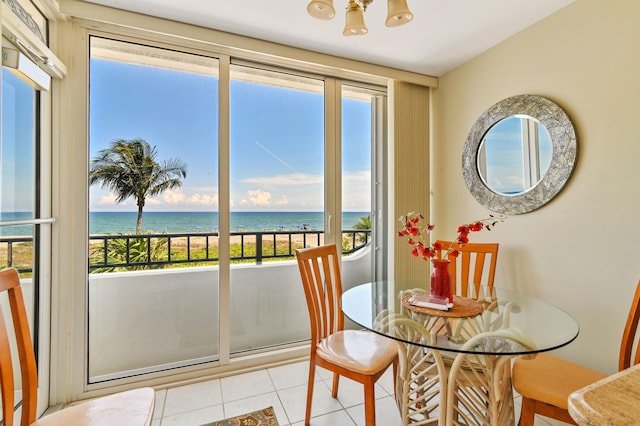 2800 S Ocean Blvd Unit 2-A, Boca Raton, FL 33432 - dining area with light tile patterned floors, a water view, and a chandelier