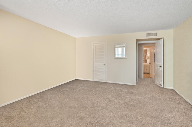 2800 S Ocean Blvd Unit 2-A, Boca Raton, FL 33432 - carpeted empty room featuring visible vents, a textured ceiling, and baseboards