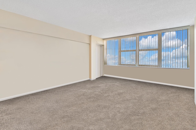 2800 S Ocean Blvd Unit 2-A, Boca Raton, FL 33432 - spare room with baseboards, dark carpet, and a textured ceiling