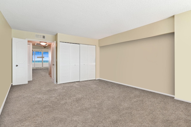 2800 S Ocean Blvd Unit 2-A, Boca Raton, FL 33432 - unfurnished bedroom with a closet, carpet flooring, a textured ceiling, and visible vents