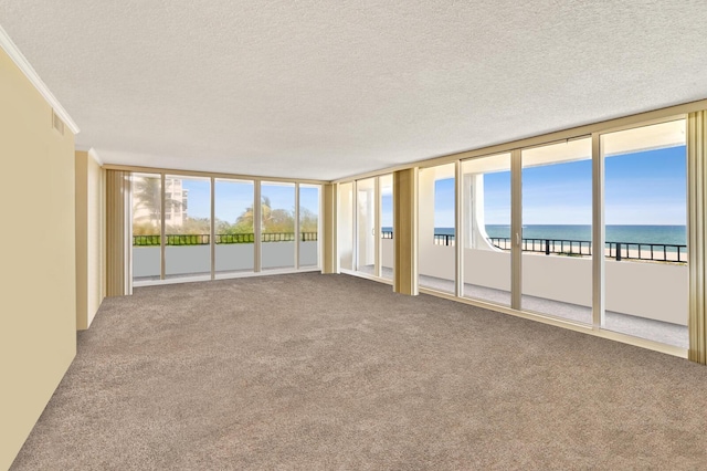 2800 S Ocean Blvd Unit 2-A, Boca Raton, FL 33432 - unfurnished sunroom featuring crown molding, a textured ceiling, carpet, and a water view