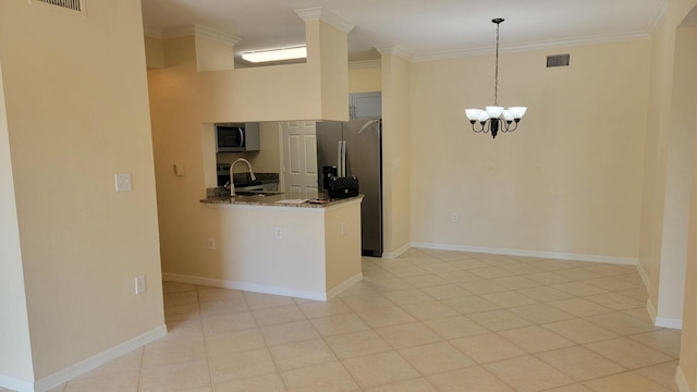 kitchen featuring ornamental molding, an inviting chandelier, sink, hanging light fixtures, and appliances with stainless steel finishes