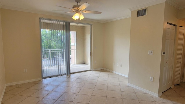 spare room featuring ceiling fan, crown molding, and light tile patterned flooring