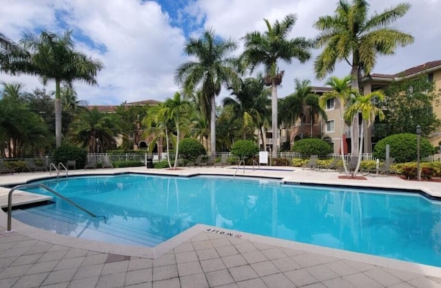 pool featuring a patio area and fence