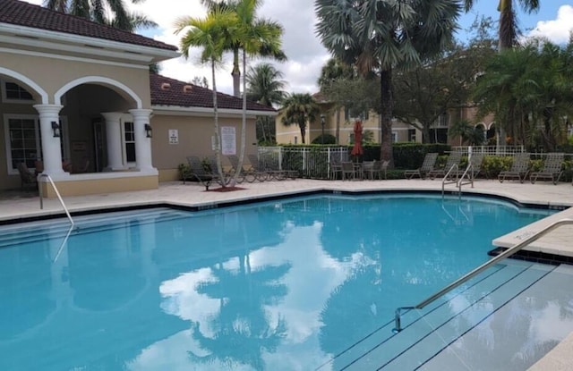 view of swimming pool with a patio