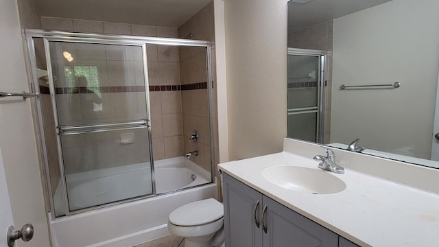 full bathroom featuring shower / bath combination with glass door, vanity, and toilet