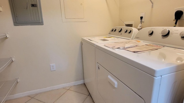 washroom with washing machine and clothes dryer, electric panel, and light tile patterned floors