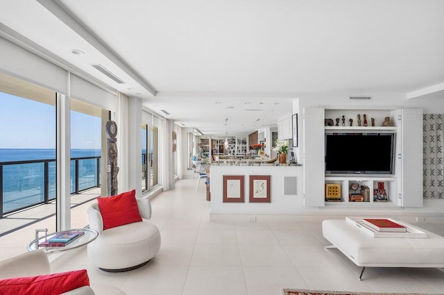 tiled living room with a water view and plenty of natural light