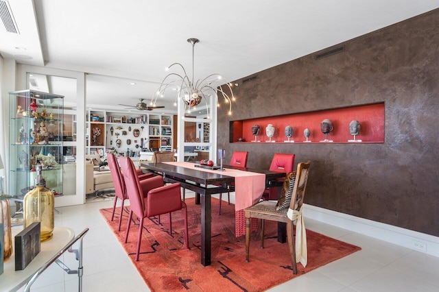 dining room with ceiling fan with notable chandelier and built in shelves