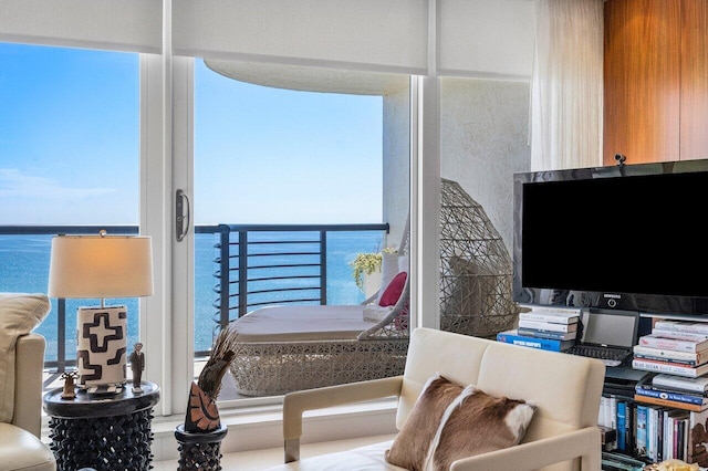 bedroom featuring a water view and multiple windows