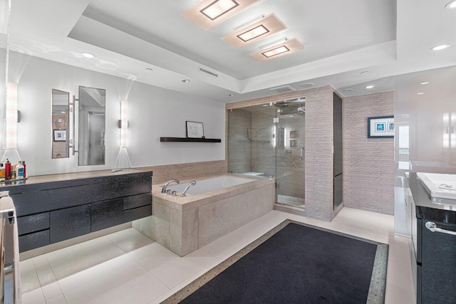 bathroom featuring a raised ceiling, vanity, separate shower and tub, and tile patterned flooring