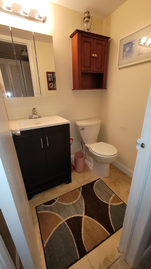 bathroom with tile patterned floors, toilet, and vanity