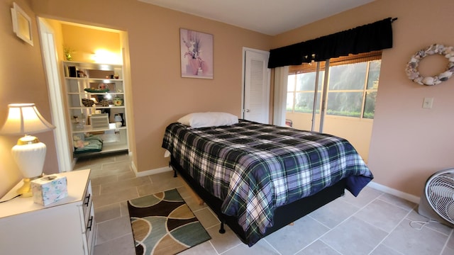 bedroom featuring light tile patterned floors and access to outside