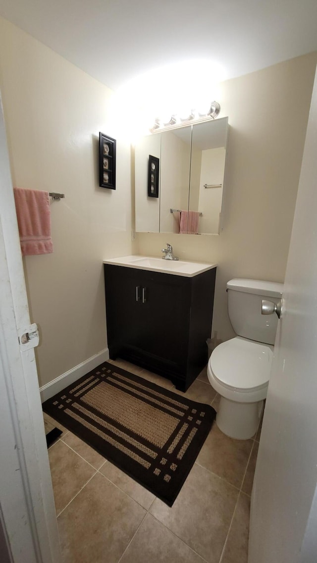 bathroom with tile patterned floors, toilet, and vanity