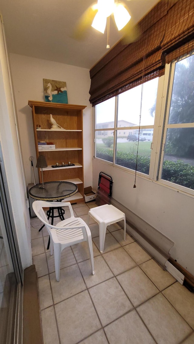 sitting room featuring ceiling fan and light tile patterned floors