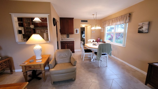 tiled dining space featuring a chandelier