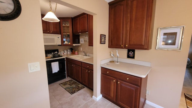 kitchen with black electric range, sink, decorative light fixtures, and light tile patterned floors