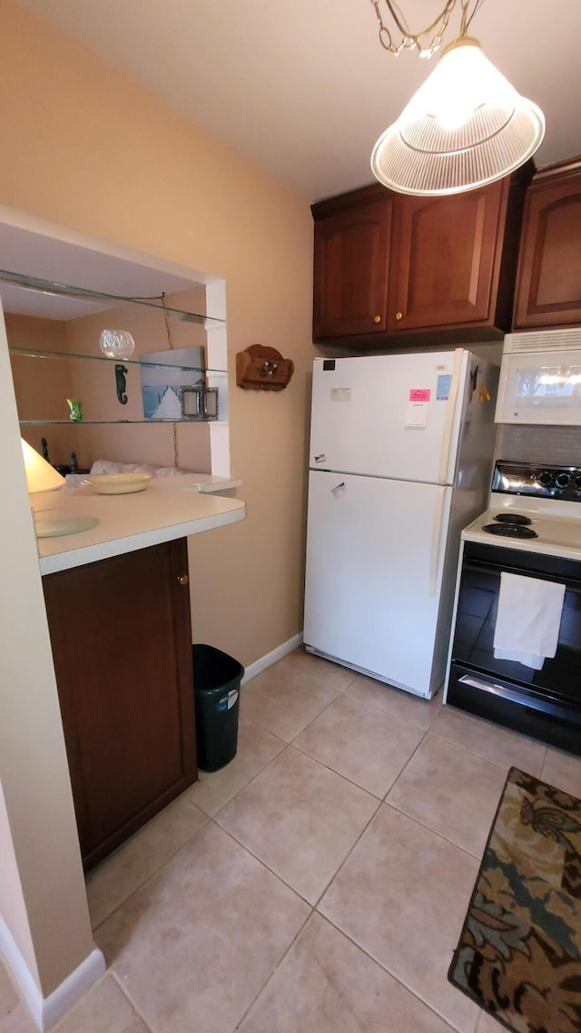 kitchen featuring white appliances and light tile patterned floors