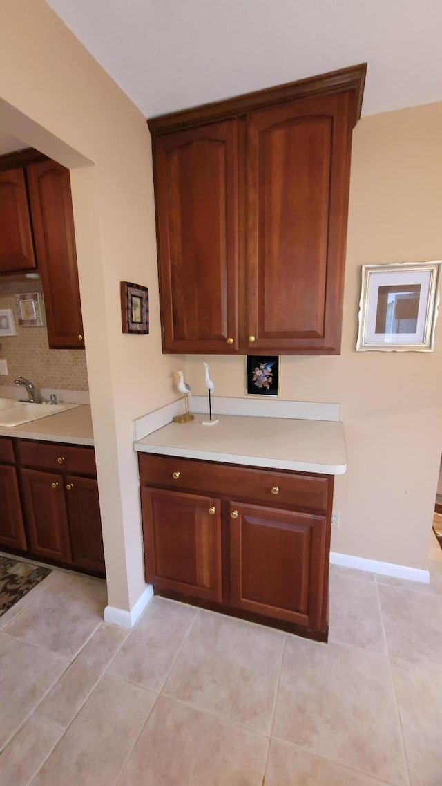 kitchen with sink and light tile patterned flooring