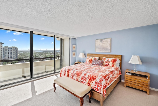 bedroom featuring carpet, a textured ceiling, and access to outside