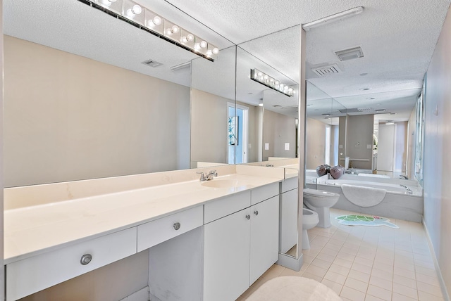 bathroom with vanity, a bathtub, a bidet, tile patterned floors, and toilet