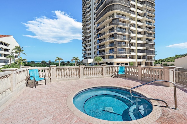 view of pool featuring a patio area and a hot tub