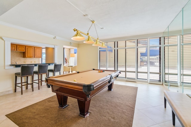 rec room with bar, crown molding, light tile patterned flooring, and pool table